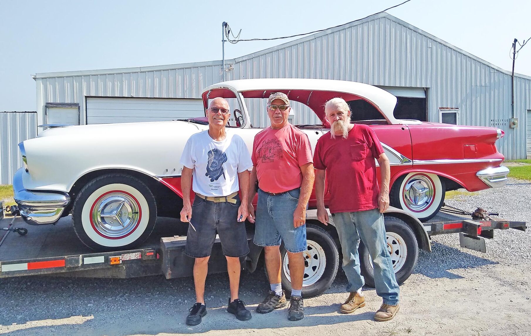Decked out in Alcan White over Festival Red, this ‘56 Olds Holiday Sedan will soon be cruisin’ in style! Left-to-right, Randy Gower, proud owner of the Olds; Phil Carrico, good friend and the one who found the Olds for sale in St. Charles and Bob Murphy, upholsterer extraordinaire who installed the headliner.
